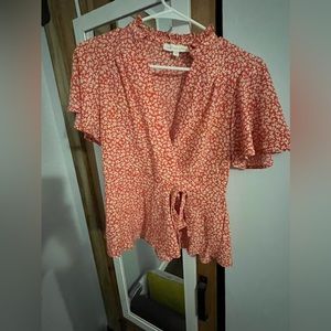 Cropped red patterned shirt.